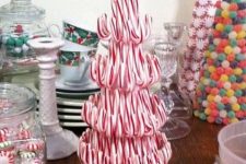 a pretty and fun candy cane Christmas tree with a peppermint on top is a fun and creative edible idea for your party