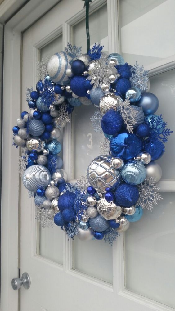 a super bold Christmas wreath in silver, light and bold blue, with snowflakes and beads is a lovely and bright idea