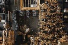 a super glam Christmas decor in black and gold, with a gold tree and black ornaments, gold candles, gold glitter touches and lots of lights