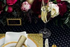 a tablescape with a lush floral garland, gold glitter touches, a polka dot tablescape and sparkly drink stirrers