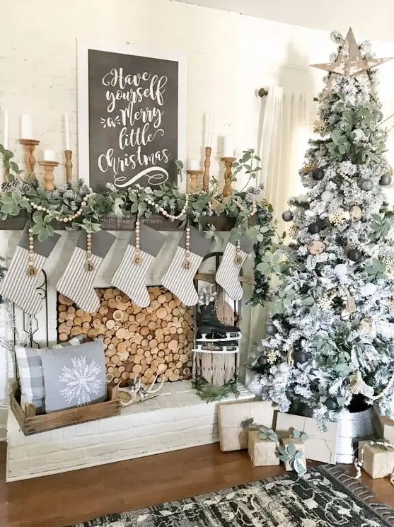 beautiful and cozy neutral rustic Christmas decor with wooden beads, greenery garlands, a black and white Christmas sign, skates and striped stockings