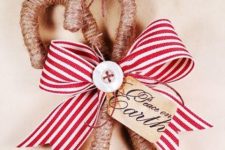 classy rustic Christmas ornaments – candy canes wrapped with twine, with buttons and a striped bow are amazing
