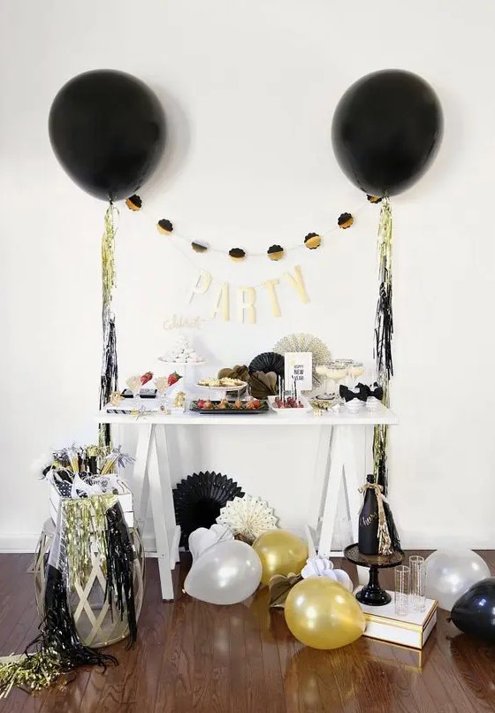 Colorful fringe and black, gold and white balloons around will make any space party like