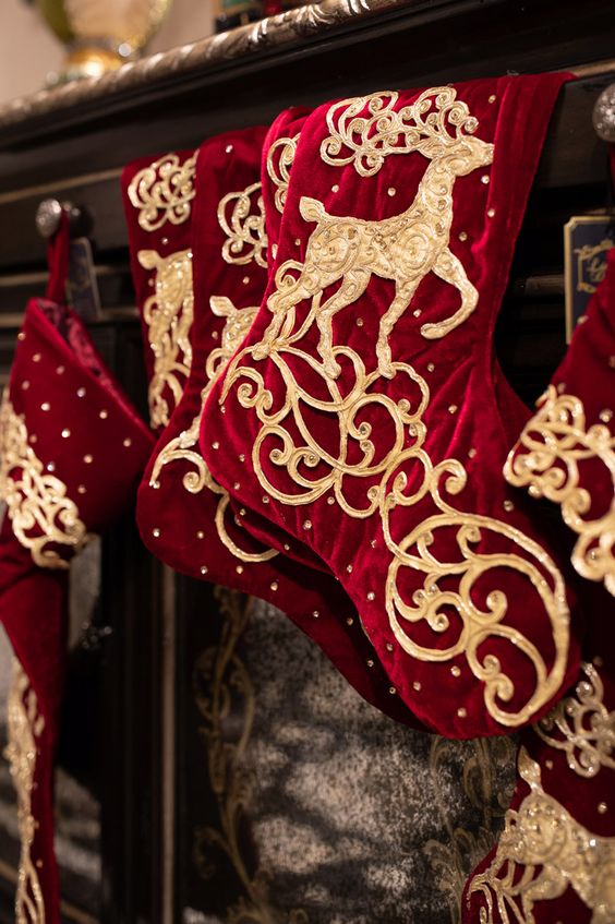 deep red and gold stockings with deer appliques and rhinestones are amazing for Christmas decor