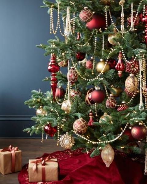 elegant red and gold Christmas tree decor with beads, ornaments, lights and gift boxes