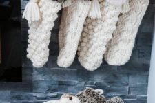 gorgeous oversized white knit stockings with faux fur and beads and tassels are great to bring Christmas spirit to your home