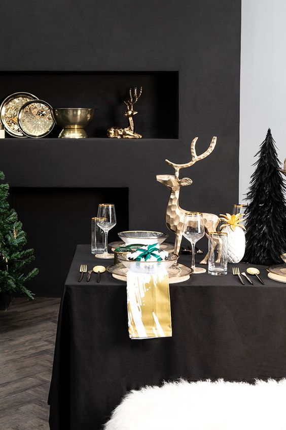 luxurious Christmas styling with gold bowls and dishes, gold deer and gold rimmed glasses and chargers is amazing