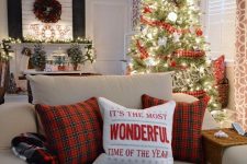 several plaid touches for a holiday feel – pillows, ribbon on the Christmas tree and a blanket for much coziness