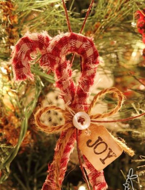 Simple rustic Christmas ornaments   plaid candy canes with buttons, twine bows and a tag are amazing for your holiday decor