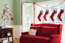 traditional red and white Christmas stockings hanging over the window is a creative way to style your space for Christmas