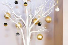 white branches and black, white and gold Christmas ornaments with various patterns is a lovely idea for holidays