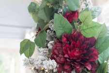 a faux greenery, burgundy bloom and grass tree topper will give it a unique feel and make it bolder and catchier