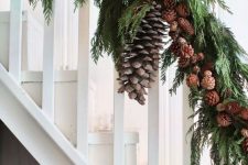 an all-natural holiday garland of evergreens, pinecones and some oversized pinecones for styling a Christmas banister
