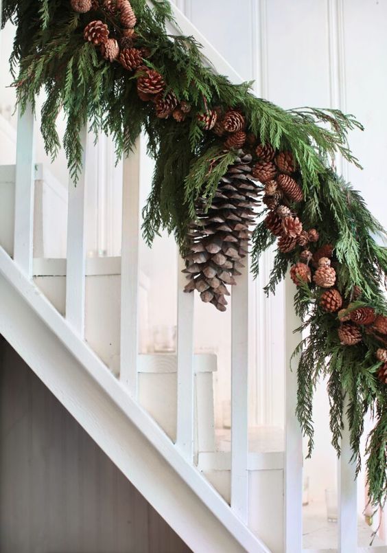 An all natural holiday garland of evergreens, pinecones and some oversized pinecones for styling a Christmas banister