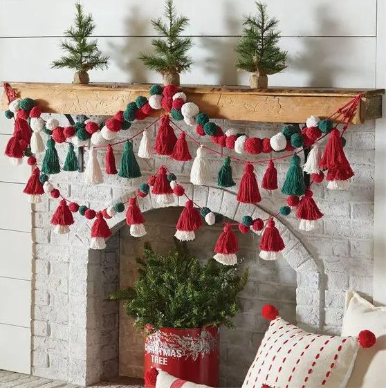 bright green, red and white pompom and tassel garlands on the mantel are a cool and fun decor idea