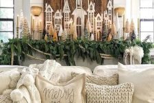 farmhouse Christmas decor with greenery, evergreens, mini Christmas trees, candles and other stuff