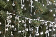 garlands of tiny silver bells are amazing to decorate your Christmas tree and you can also hang them somewhere else, too