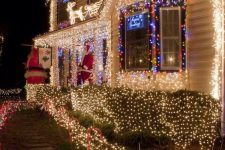 lights covering the whole house, lining up the path and some figurines made of lights make this house absolutely gorgeous and Christmas-ready