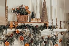 lovely Christmas garlands of dried citrus slices, evergreens and bells are great to style a mantel