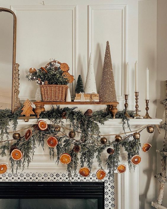 lovely Christmas garlands of dried citrus slices, evergreens and bells are great to style a mantel