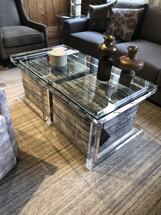 a clear glass coffee table with large upholstered ottomans with storage space inside