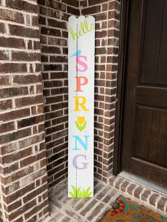 a colorful spring sign with grass, birdies and a bloom is fun and easy to make yourself