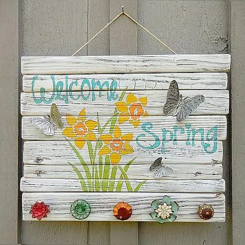 a colorful vintage spring sign with bold blooms and letters, with vintage knobs and butterflies is cool