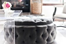 a large round tufted ottoman can be placed under the coffee table and you can store stuff inside it