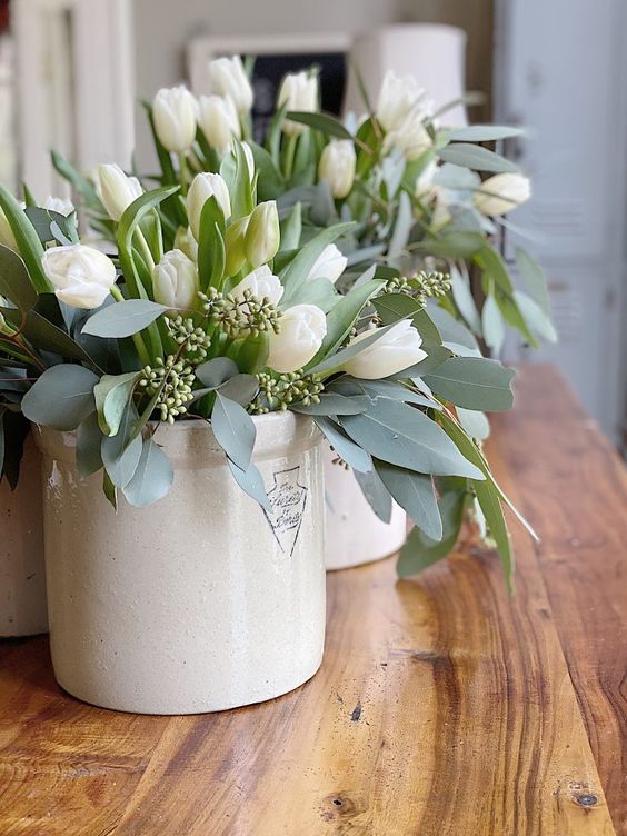 white vases with white tulips and eucalyptus are classics for spring and they will refresh your space at once