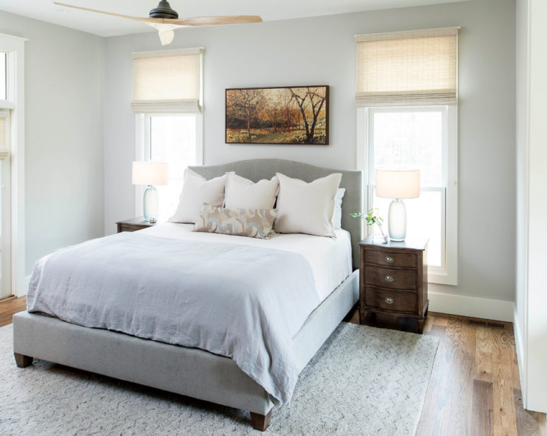 a neutral farmhouse bedroom done in powder blue and grey, with wooden furniture and much natural lights  (Chelsea Benay, LLC)