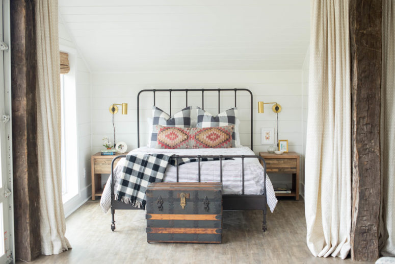 a neutral farmhouse bedroom with wooden nightstands, a forged bed and a chest for storage   (Sarah Catherine Design)
