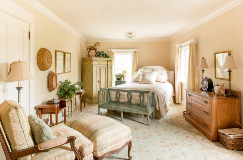 a cozy and welcoming farmhouse bedroom done in neutral shades, vintage furniture and printed textiles (Rikki Snyder)