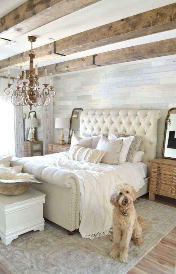 a chic famrhouse bedroom with wooden beams, elegant furniture and a crystal chandelier