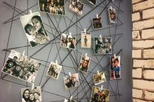 a creative wall mural of yarn with color and black and white photos attached to it here and there is super cool