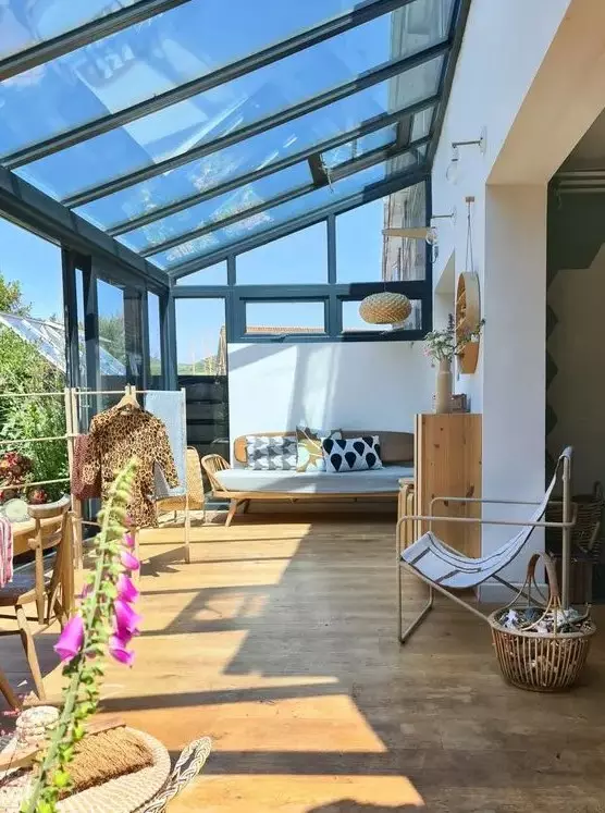 a mid-century modern sunroom with plywood and metal furniture, printed textiles and a dining space in the sun