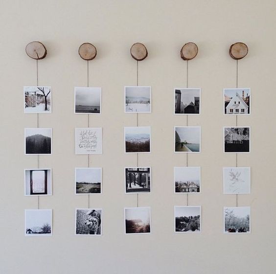 a nature-inspired gallery wall with Insta pics hanging on yarn from wood slice hooks is a cool idea