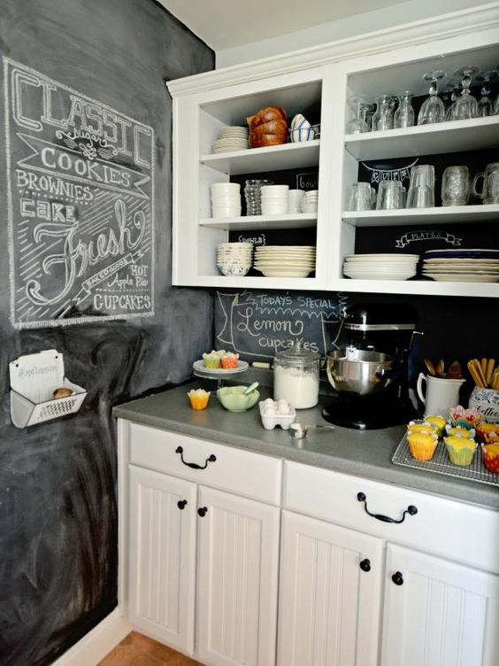 a neutral farmhouse kitchen with a chalkboard wall and backsplash is a stylish space to be and it feels very cozy and inviting