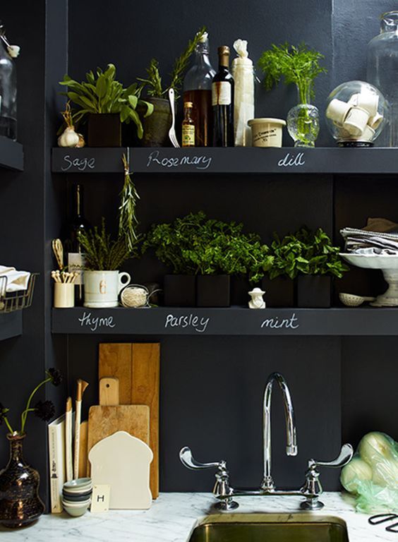 Chalkboard walls with built in open shelves over the whole kitchen are great for any kinds of marks, messages and other stuff