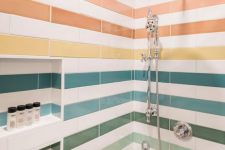 a colorful rainbow shower space with bright tiles that create stripes is a lovely and cool solution if you love color