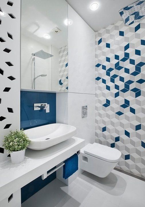 a contemporary bold blue and white bathroom with a geo tile wall, a wall-mounted vanity with white appliances