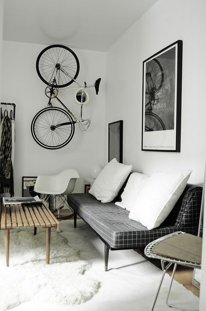 a creative bike holder on the wall that allows storign it vertically is a lovely idea for a Scandinavian space