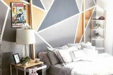 a modern bedroom with a geometric wall mural, a wooden canopy bed, neutral bedding, mismatching nightstands and a black chest