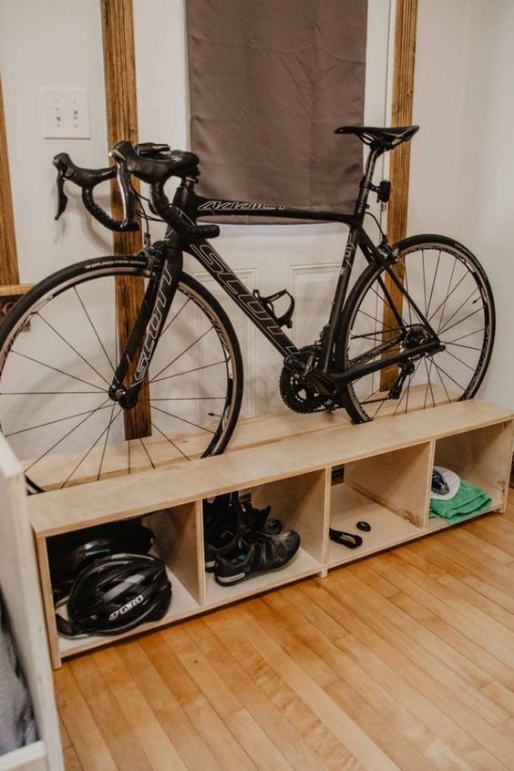 a pallet storage shelf with a bike and various stuff related stored comfortably here is a great idea for a any room