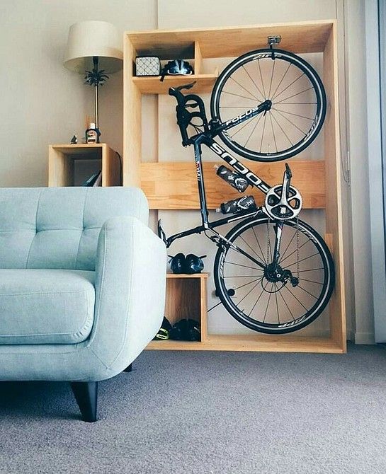 an open plywood storage unit with a bike and various stuff stored is a cool idea for a modern space and this unit can be placed even in a living room