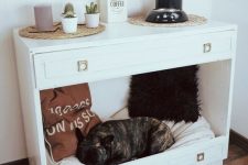 a hacked dresser to become a dog’s bed