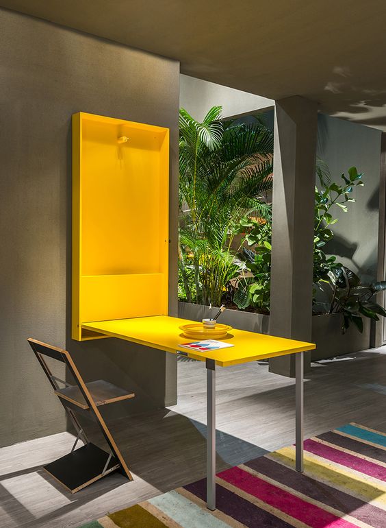 a folding desk or dining table in sunny yellow can be hidden anytime, and the chair is folding too
