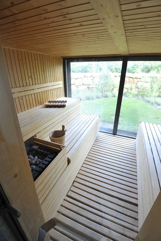 a home sauna with a glass wall, clad with wood is very welcoming and very inviting