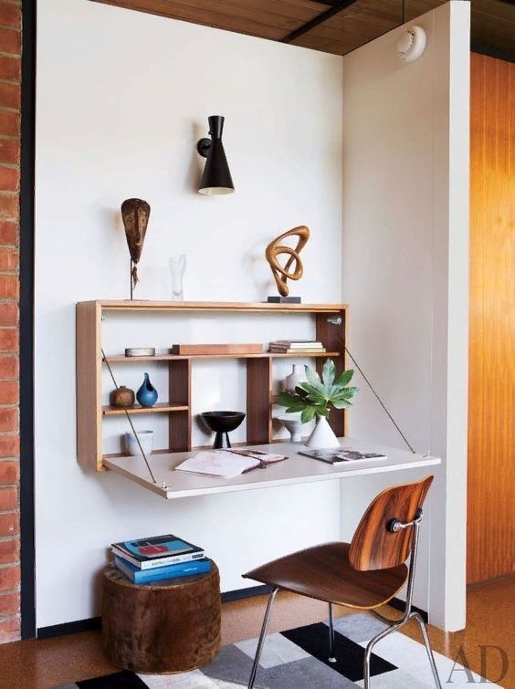 a large wall-mounted storage unit with a foldable desk is a great solution for a awkward nook
