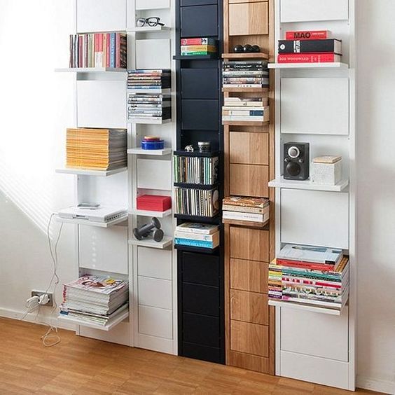 A large wall mounted storage unit with various foldable shelves that can be hidden anytime