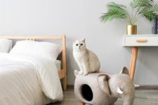 a neutral elephant cat bed that doubles as an ottoman is a cool and chic idea for a modern space